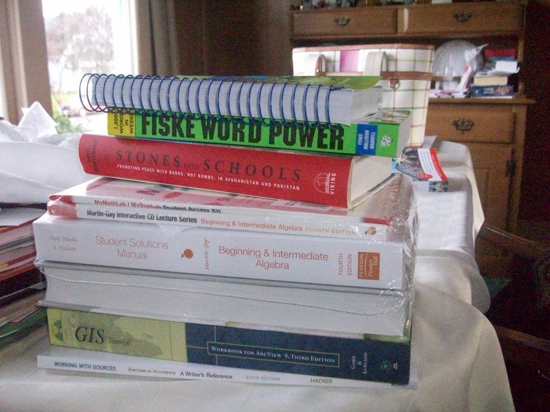 These(the stuff in the center of the photograph not on the left) book/CDs and other content needed for my classes currently cost $403.42 This is why you should apply for scholarships or get financial aid/ or work off the mo