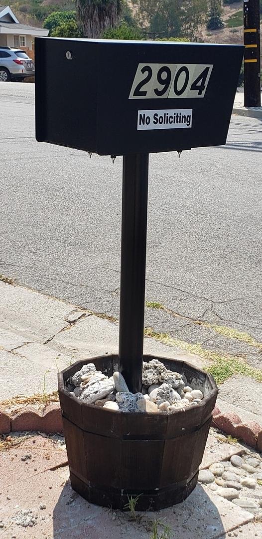 Finally got the new mailbox that unlocks from the back up. No more walking out on that bad gutter with our walkers to get the mail. Hired my former gardener/handyman. He and a co-worker had "fun" doing this. :)