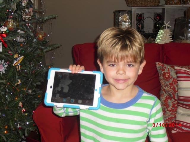 Caeden believes he caught a photo of Santa on his I pad leaving the gifts under the tree! And since the gifts in the background of the photo are the gifts that were actually under our tree Caeden is positive he has proved