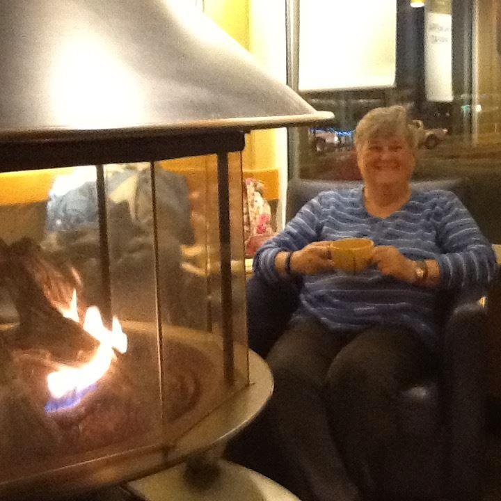 Marie enjoying the hot cocoa and fireplace