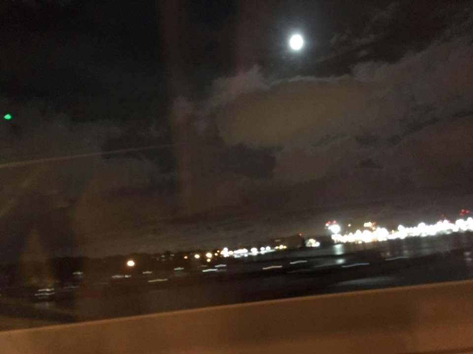 Picture of the moon from the James River Bridge in Hampton Roads VA. Newport News Shipbuilding in the foreground.