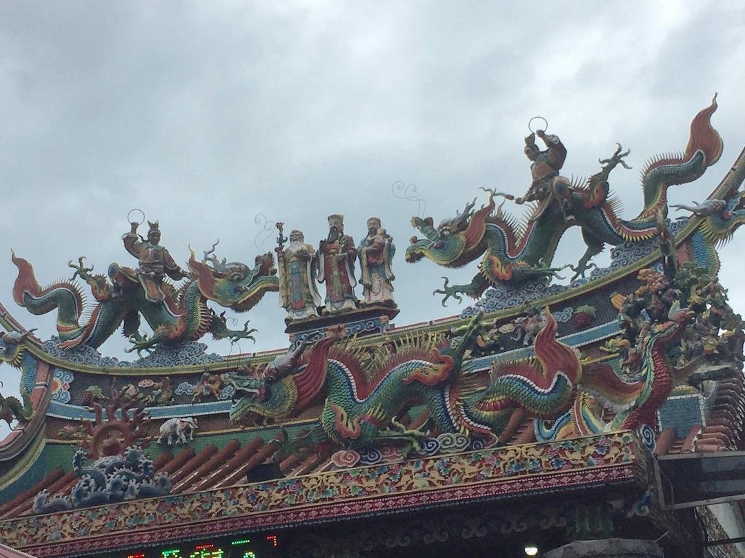 This was an interesting temple showing both a mixture of old-world and new, as there were ornate carvings in the peak of the roof, and then a motion LED sign just below the roofline that was scrolling slogans across the ent