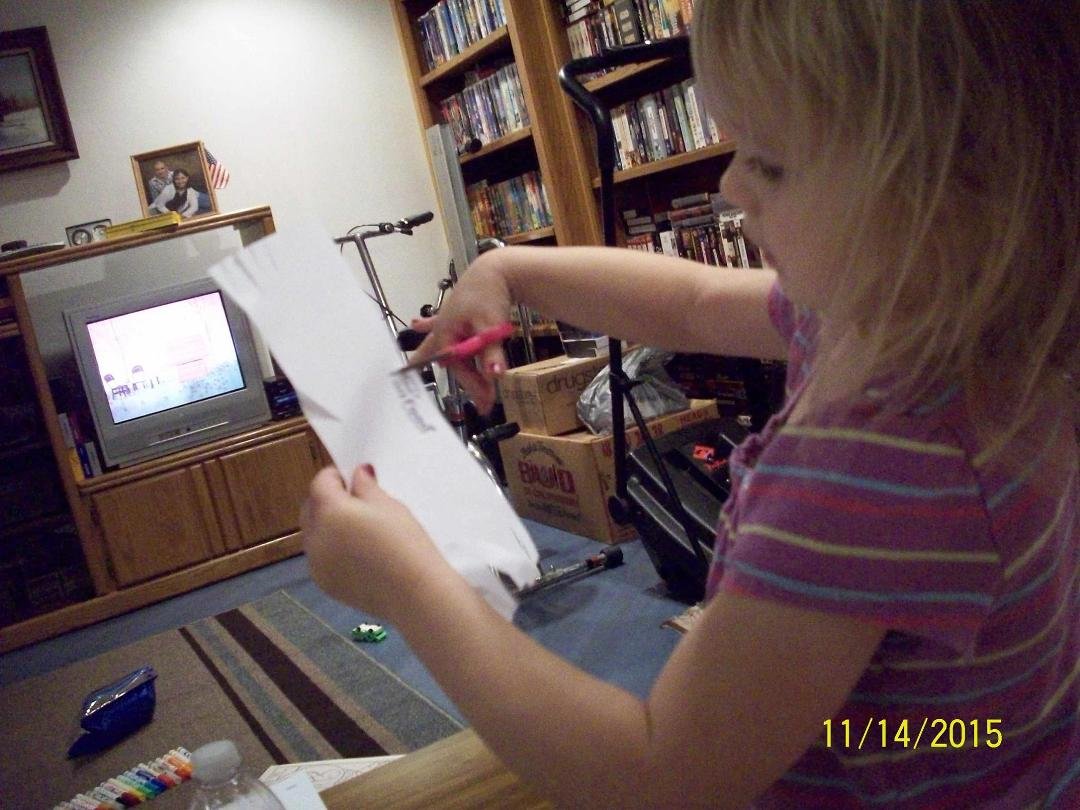 Clara cutting paper.