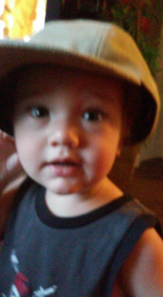 Great grandsonJoshua styling Papi's cap.