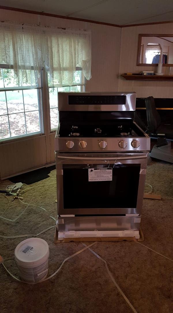 The new range is here. Waiting on the guy to come template the countertops, the off to Lowe's for a new gas supply line and 3 more paint samples