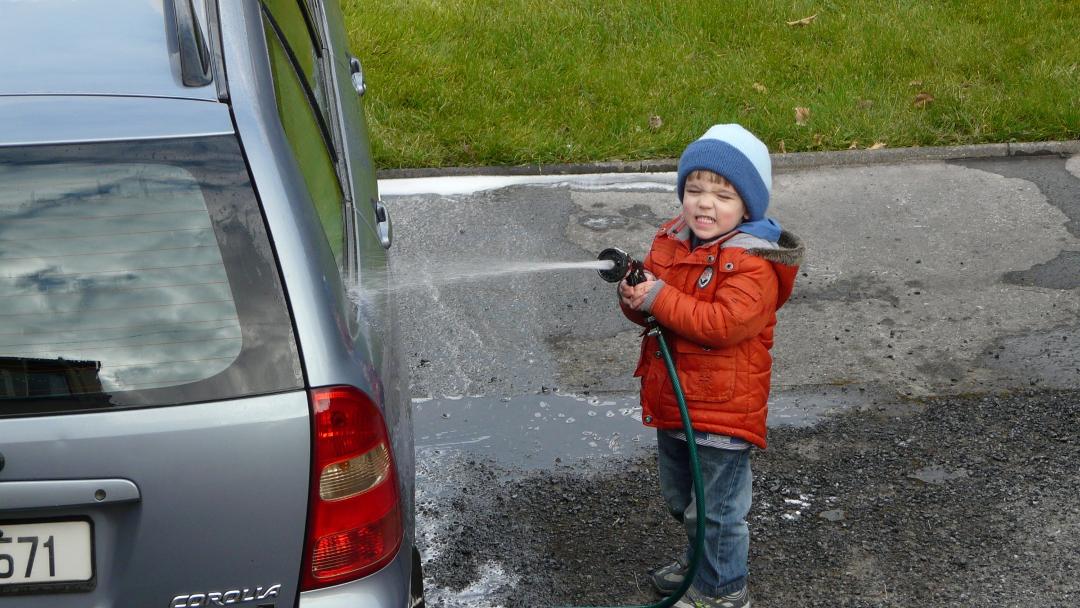 Finn helping grand dad wash the car.