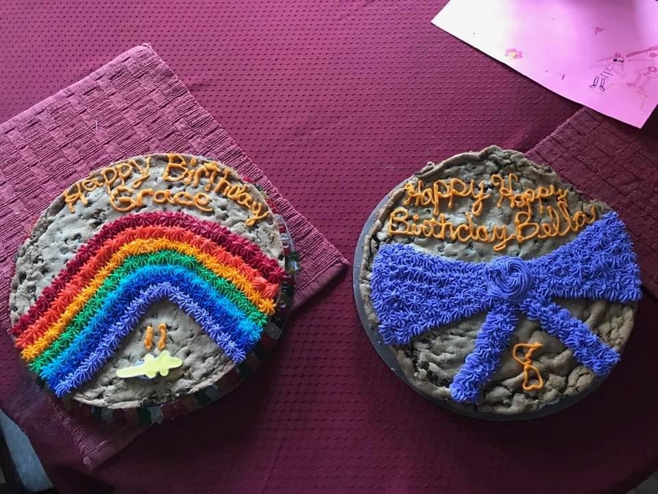 Home made cookie cakes. Grace wanted rainbows and Bella wanted a purple bow. The outside of Grace's cake is surrounded by Gummy Bears.