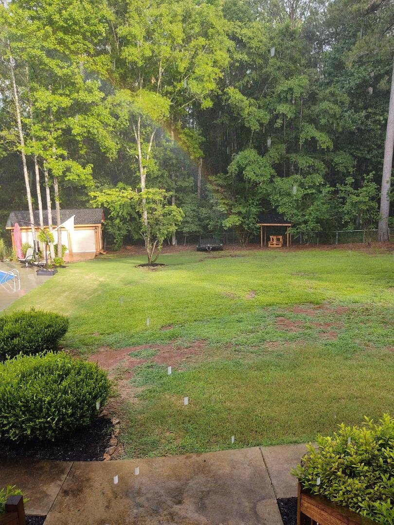 Raining here but we have a rainbow landing in our backyard! Wow!!