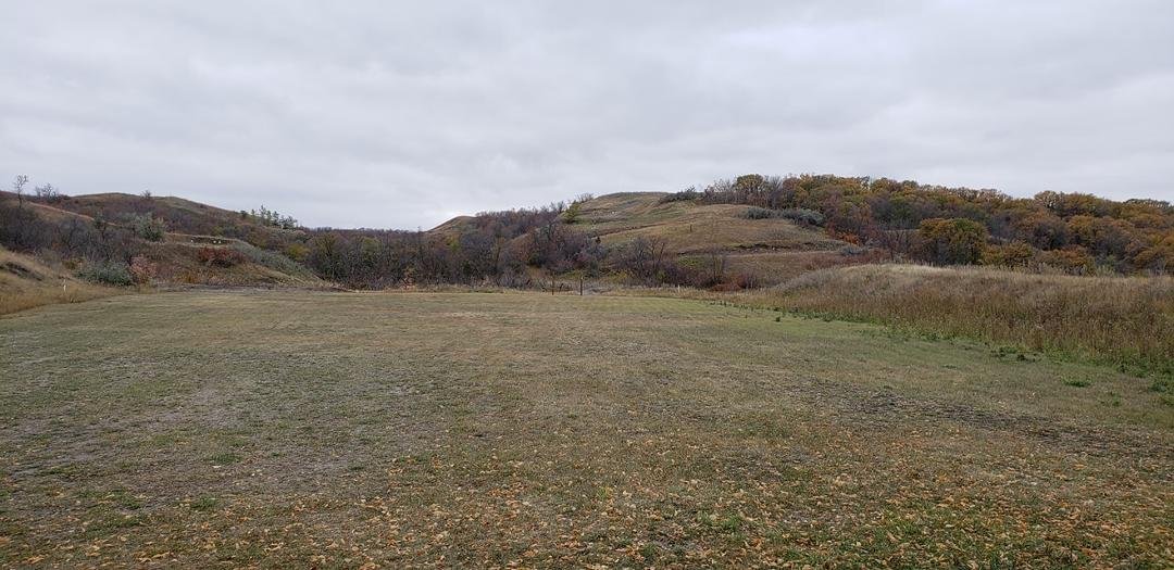 Here is what a 750yd target looks like without magnification. The target is right down the middle just below the slanted hill.