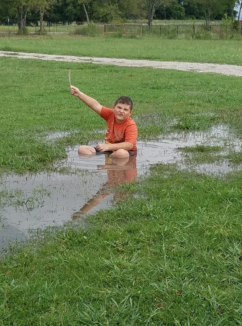 My grandson, Jackson, is one with his mud puddle.
