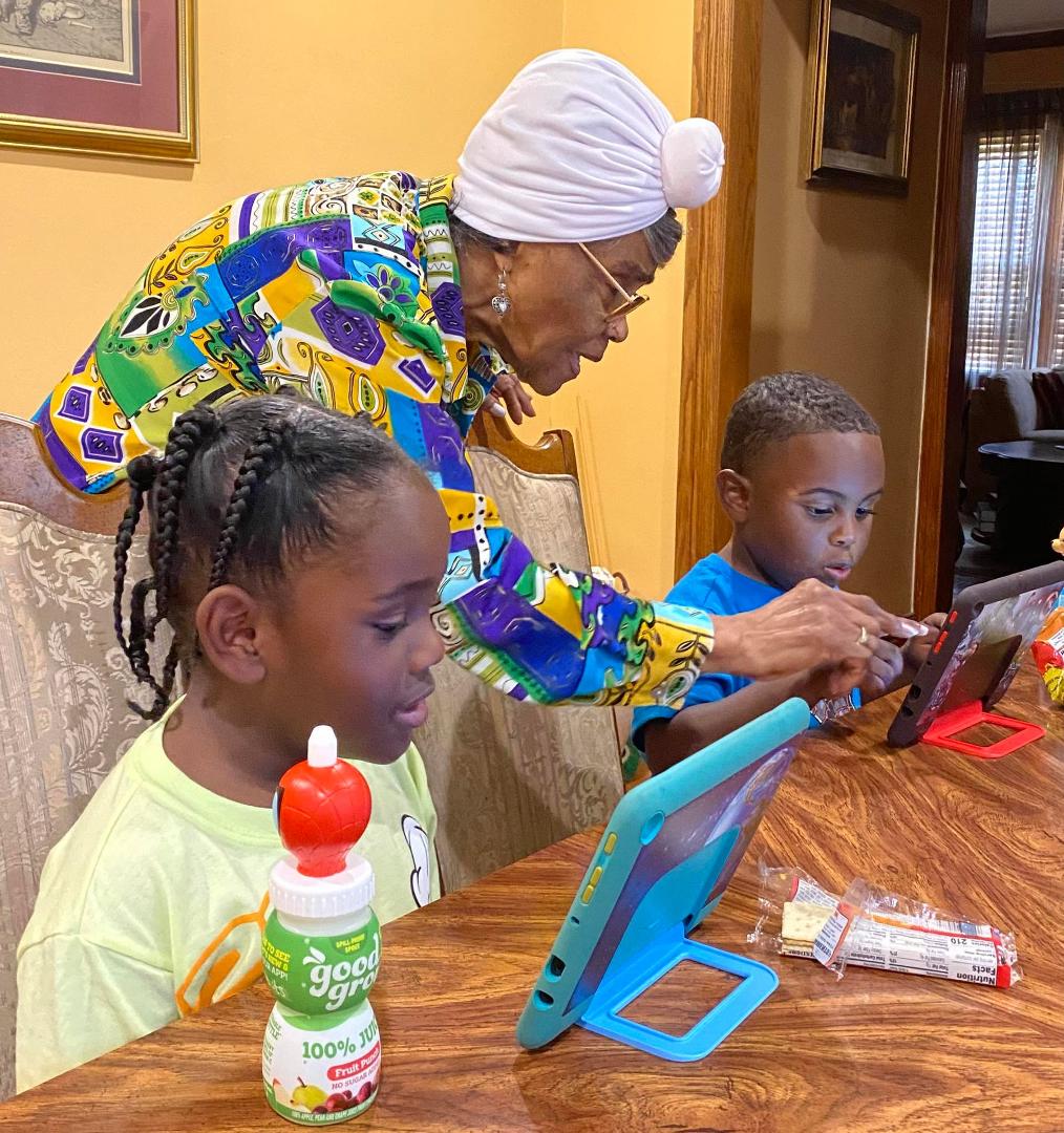 Lurlie teaching her great-grandsons.