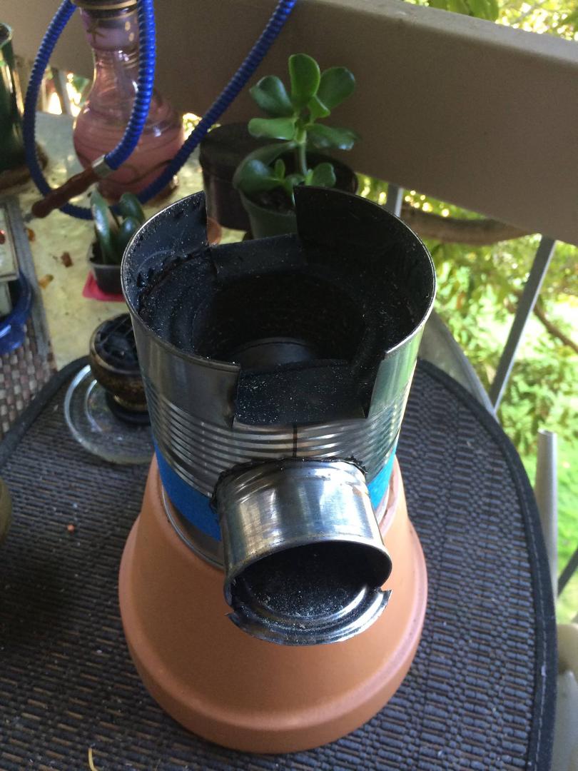 Mindless Saturday, I'll never grow up, built a Rocket stove! Used in countries with minimal combustible fuel for cooking. Cheap ( 3 tin cans and some gravel), virtually smokes less, requires just yard debris...sticks, drie