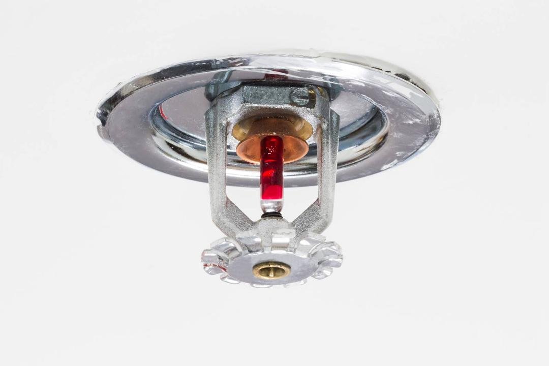 Since I'm all full of smart-ass facts today, here's another about a common movie misconception: Sprinklers do not automatically activate when you pull a lever or detect smoke. How do they really work? Heat over 155 degrees