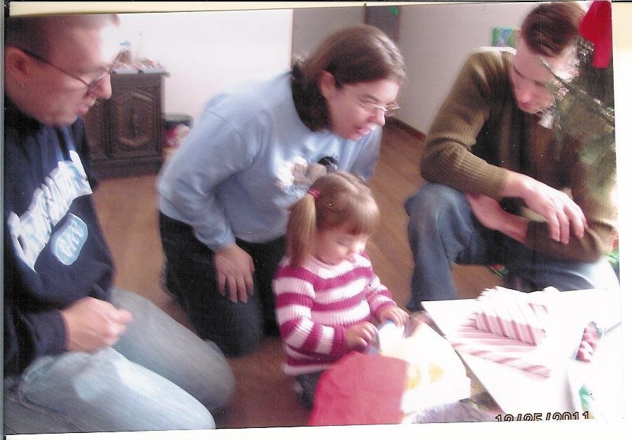 Everybody wathcing Avery opening her packages.