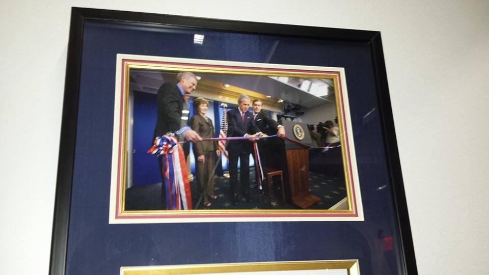President Bush cutting a ribbon.
