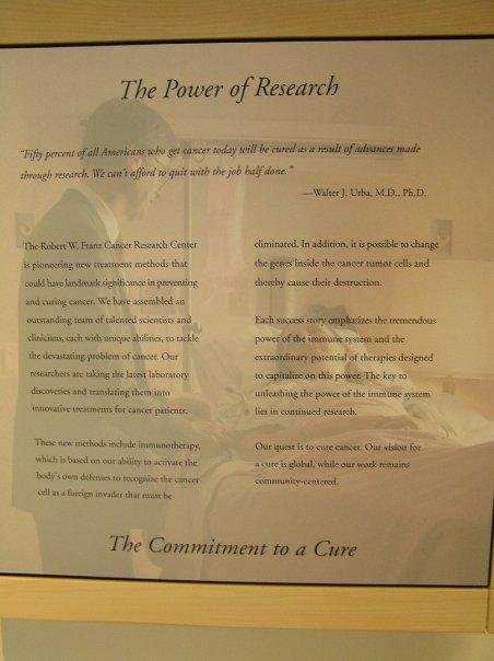 Plaque at the Robert W. Franz Cancer Research Center at Providence Hospital, Portland Oregon. In the background is Dr. Walter Urba and Karen Bender McCuen.