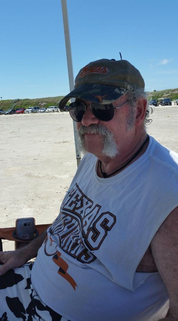 A beach boy with a feather in his hat.