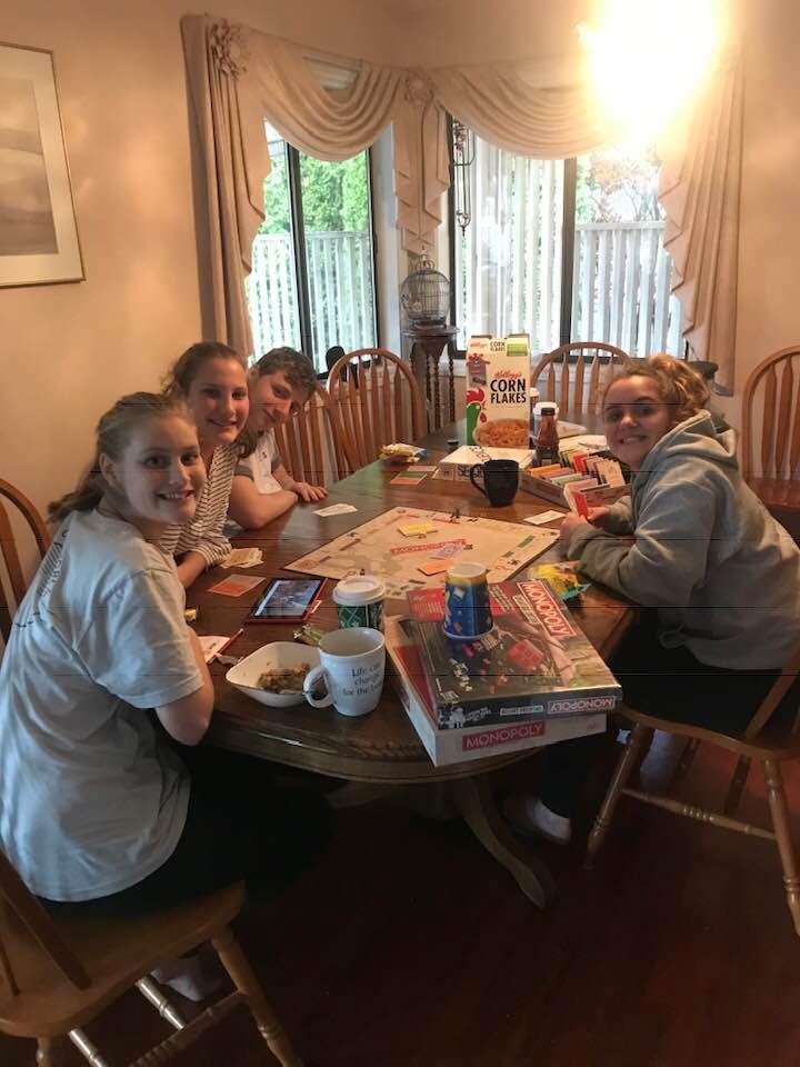 Cousins playing a spirited game of Monopoly.