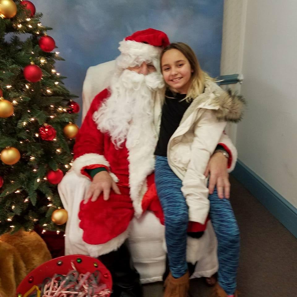 And whose lap is she sitting on?