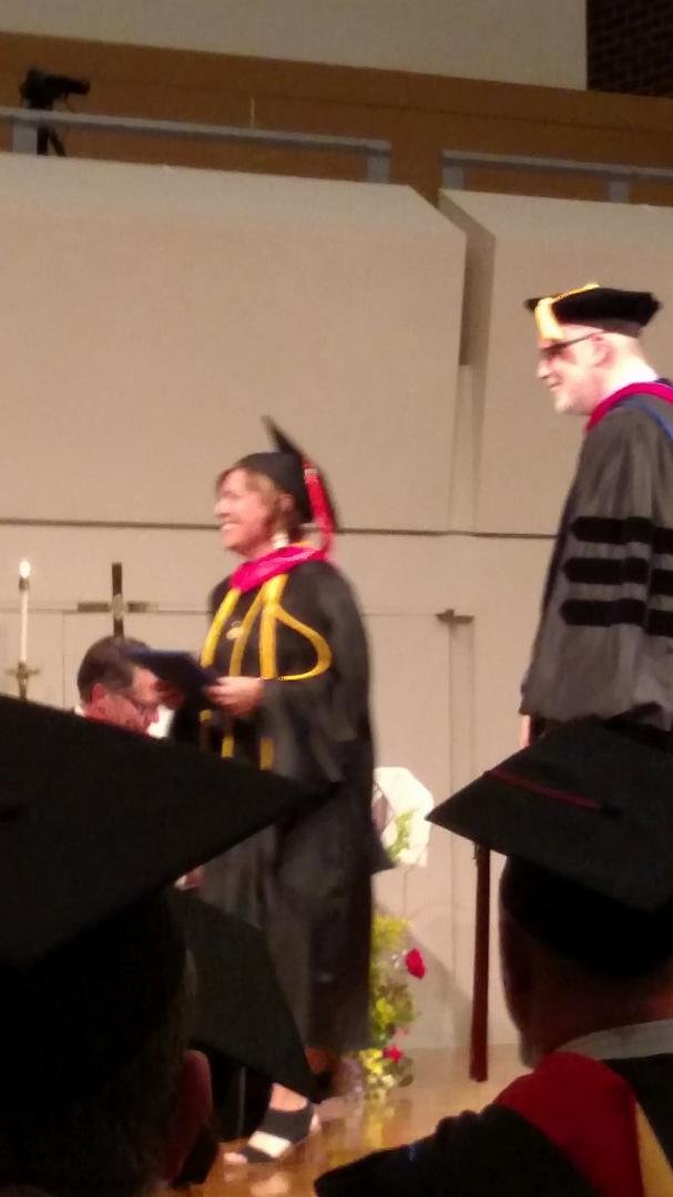 There she goes!  Graduation with diploma in hand!