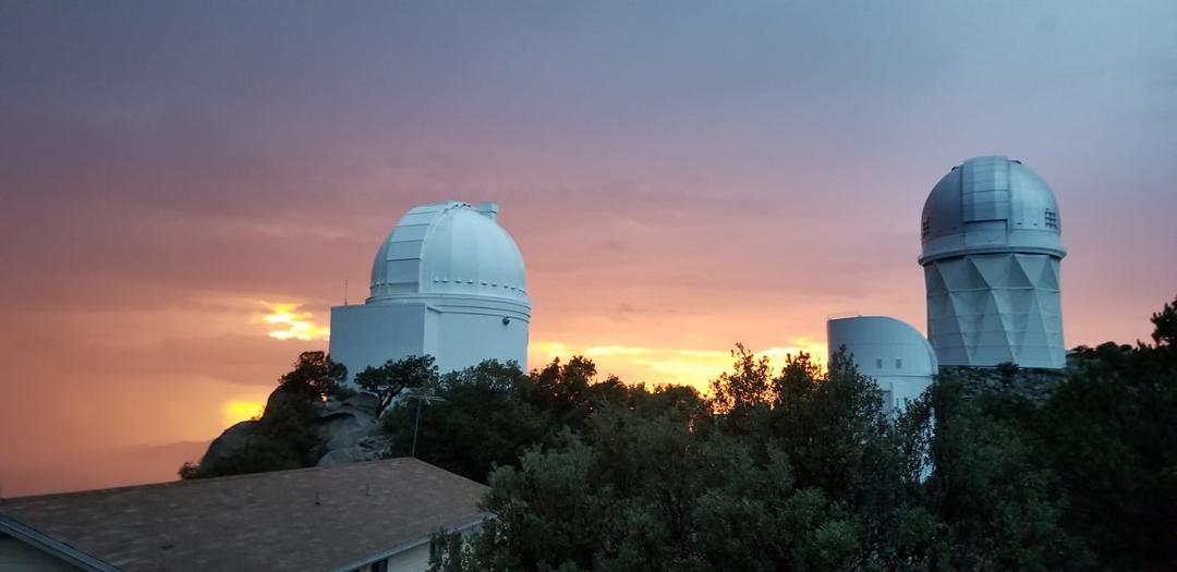 Not going to be opening domes anytime soon - a nearby thunderstorm is dropping rain in the area around Kitt Peak. Pretty sunset going on too.