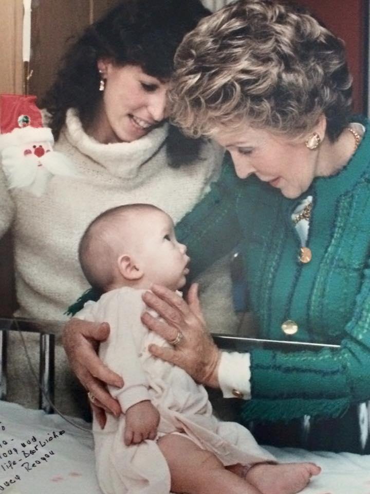 My daughter being held by Nancy Reagan at Children's Hospital. This photo was liked by Mrs. Reagan so much that it was outside of her office in the White House for 4 months.