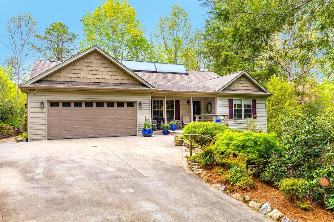 Charming, sweet home with yard that surrounds house. Beautiful landscaping features with natural stone. Covered front porch with circular seating. Flat entrance, 2 combined lots, wooded & private at the end of the cul-de-sa
