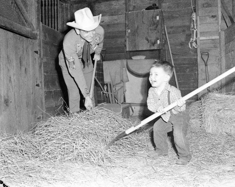 A picture of my dad and me mucking the barn at our place on Algonquin Rd.