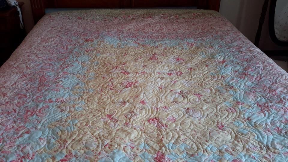 Another one I finished a few weeks ago. It is called Blooming Nine Patch. I am using it on my bed now. Eve Graf quilted both of these. I just make them.