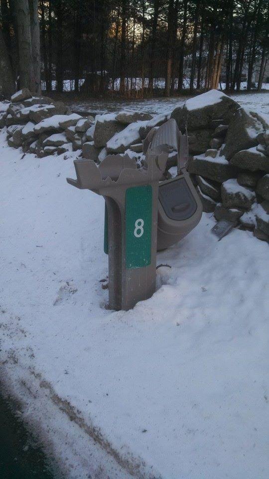 Not quite sure if this was from a baseball bat or if one of the town trucks got to paint a little mailbox on the door!
