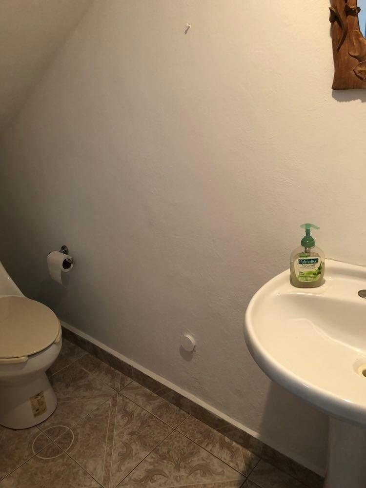 Half bath under stairs.