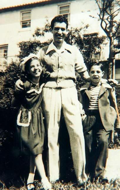 my grandpa Eddie, with his sister, Donna, and their stepdad, Sal, in front of there home inthe Bay Area