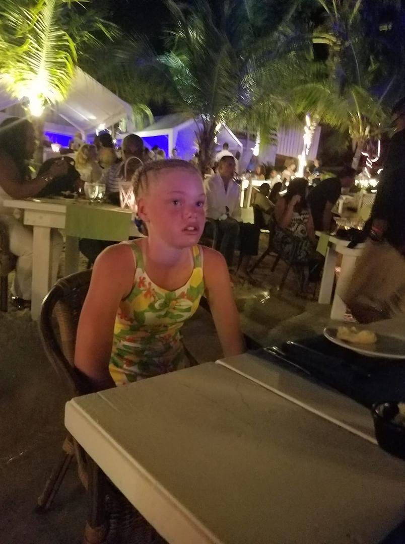 In Aruba, at the Flying Fishbone with our feet in water at dinner table.