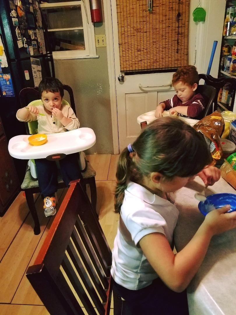 My babies eating yogurt with blueberries.