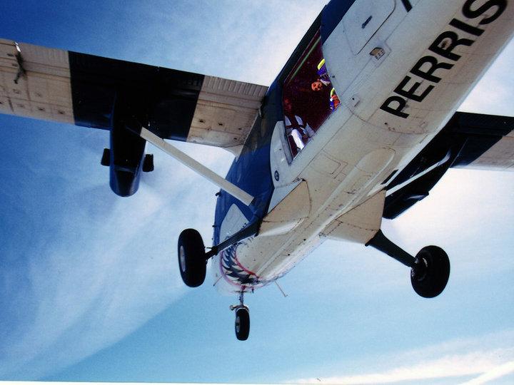 Getting ready to do a practice smoke jump at Jim Wallace's Demo School.  Lori snapped this pic just after her exit.  That's me up there in the plane about to jump out next.  Doesn't seem like this picture was taken at over 
