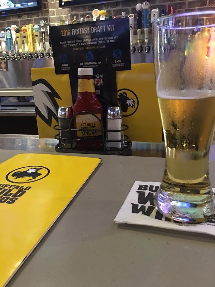 joying a cold beer and some wings
