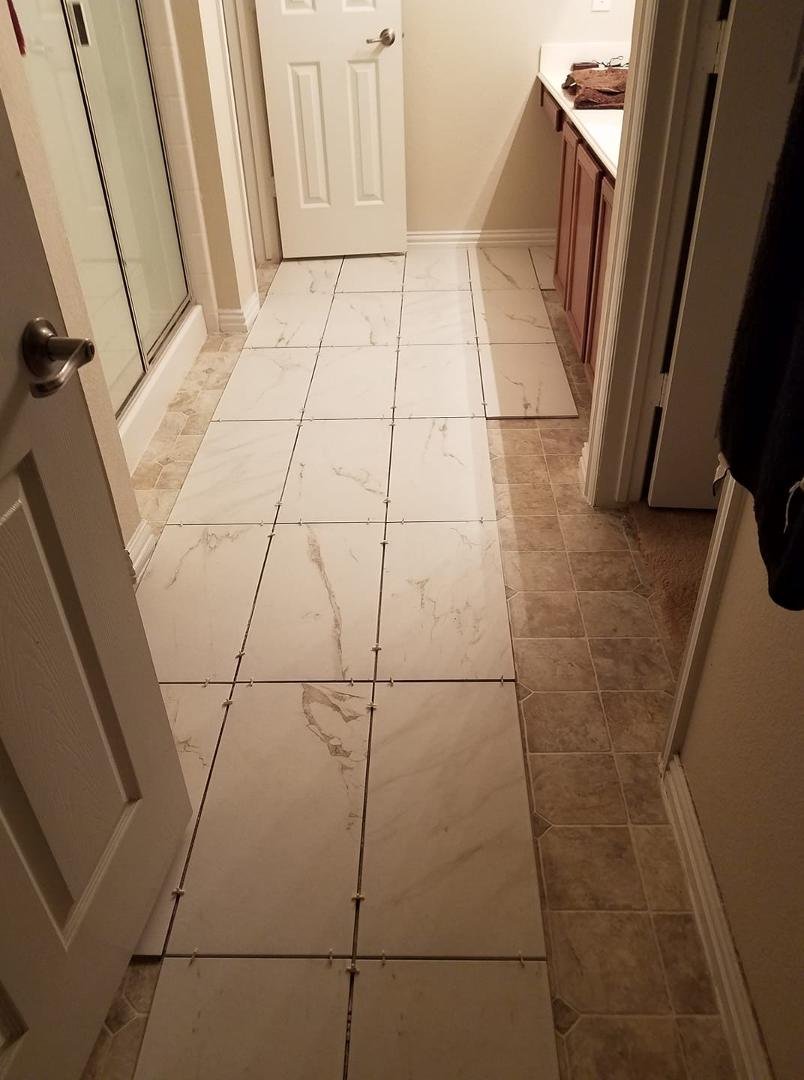 Laying tile in my master bedroom. Not bad so far, being only my 2nd time doing it this time by myself.
