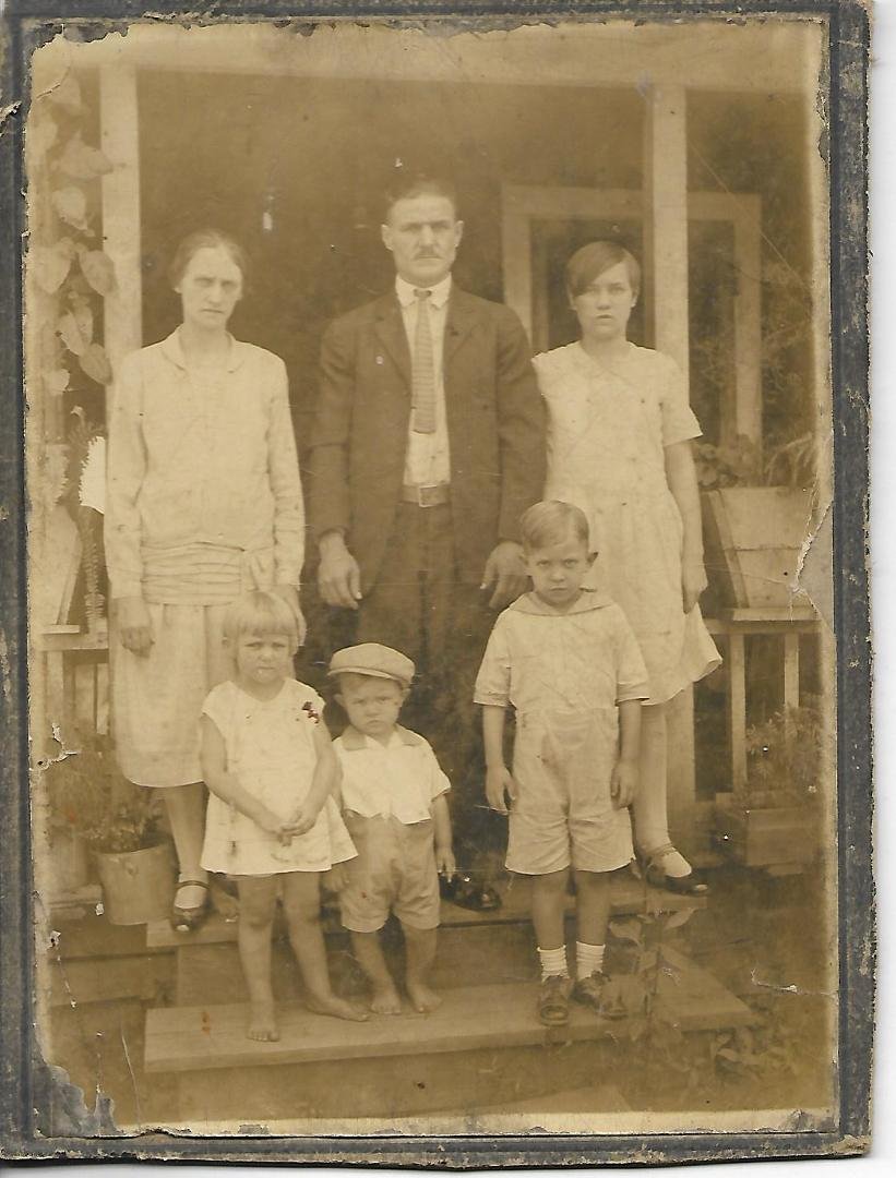 I found this with photos of my Mother's Parents -- Floyds.  It was not dated and no names and was glued to cardboard baking.   Thinking it is our Floyd family ancestors.   We came from humble beginnings...