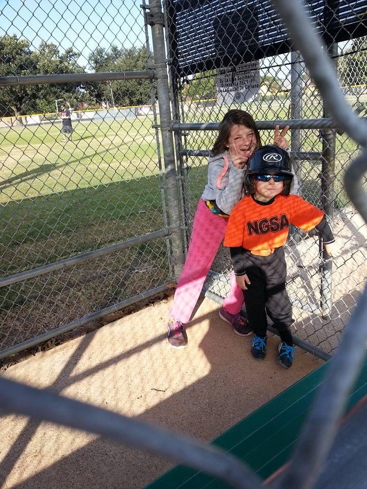 Last T-ball game of season, with big sister to cheer him on.