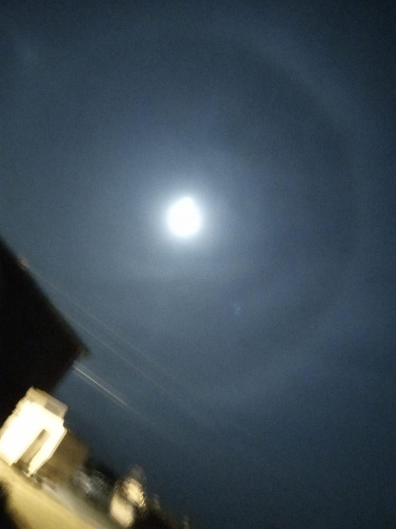 Ring around the moon from the haze. I tried different exposures to catch it. I was good with the old manual 35mm.