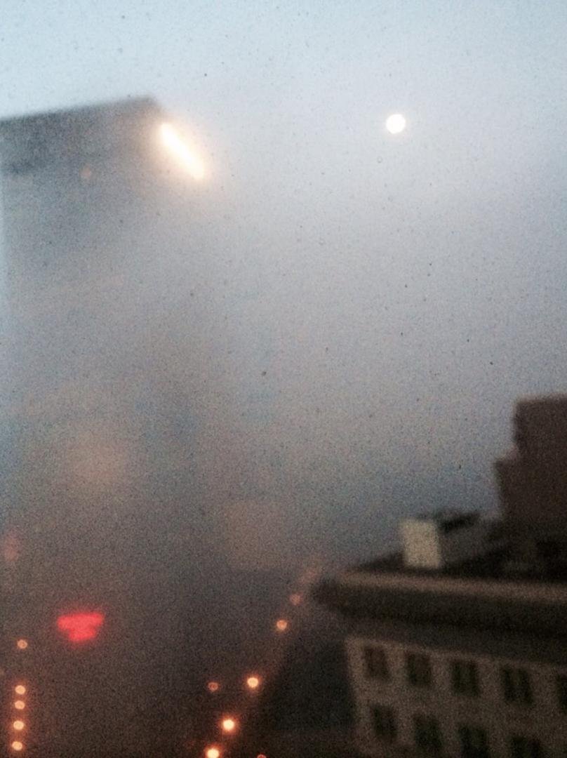 Foggy morning in Atlanta. The Equitable building and full moon barely visible.
