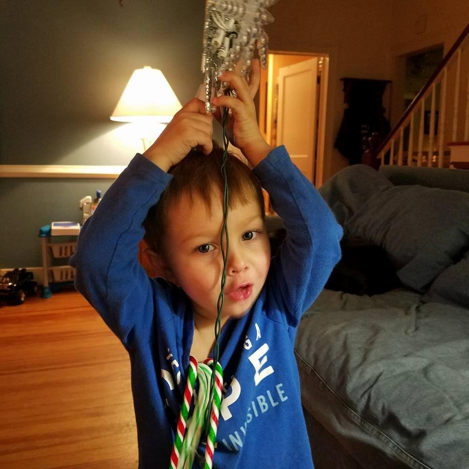 Zane with star from Christmas tree on his head.