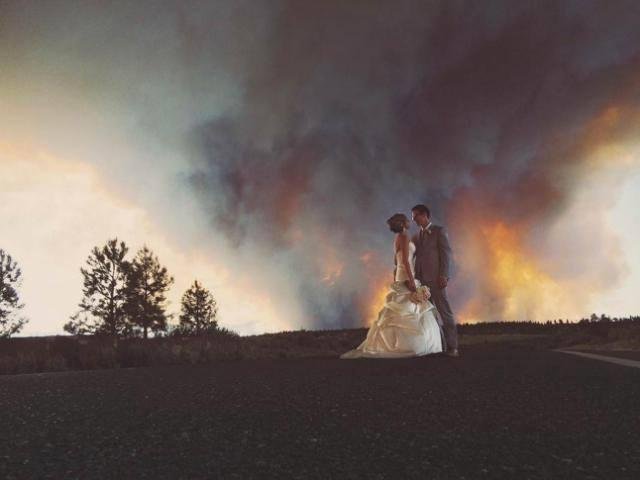 Is This the Best Wedding Photograph Ever? 

A couple scheduled their outdoor wedding months in advance but a raging fire almost disrupted the plans. The couple decided to go ahead anyway, despite the fire. Nothing can stop 
