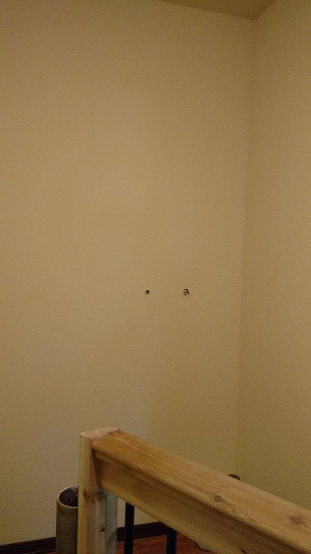 HOLES IN WALL TOP BASEMENT STAIRS