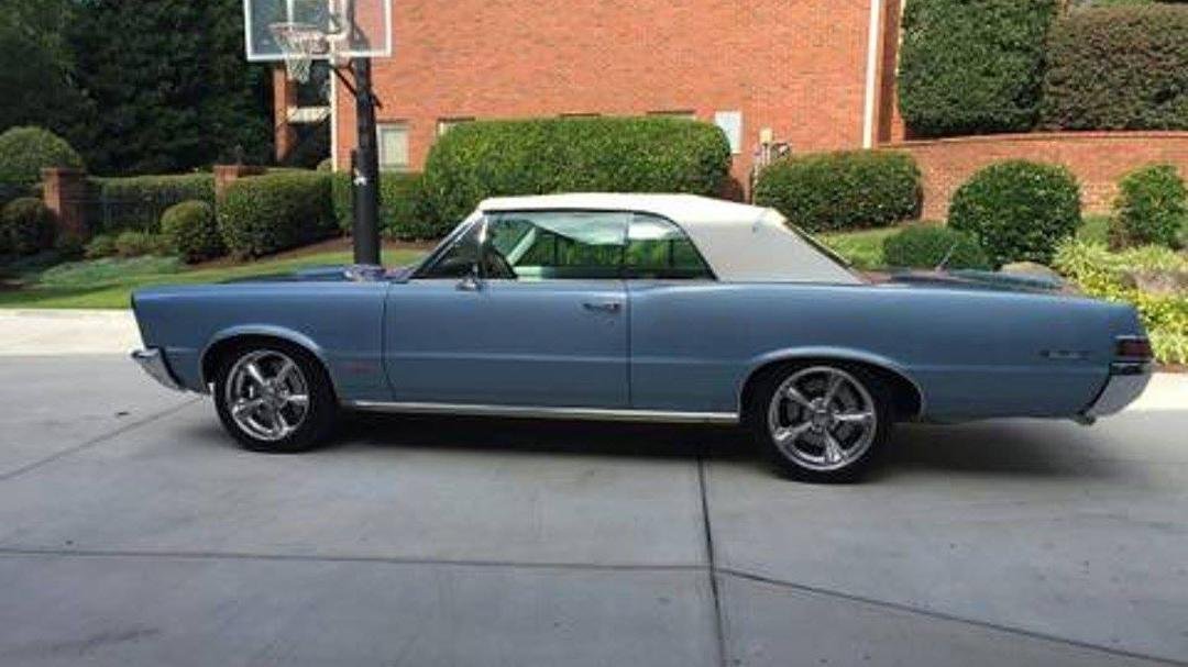 I saw a 1965 Pontiac GTO Today. If you know me well, you know this has been my dream car since I was four years old. My best friends's dad owned one for years and I just loved to hear him rev the engine. They certainly