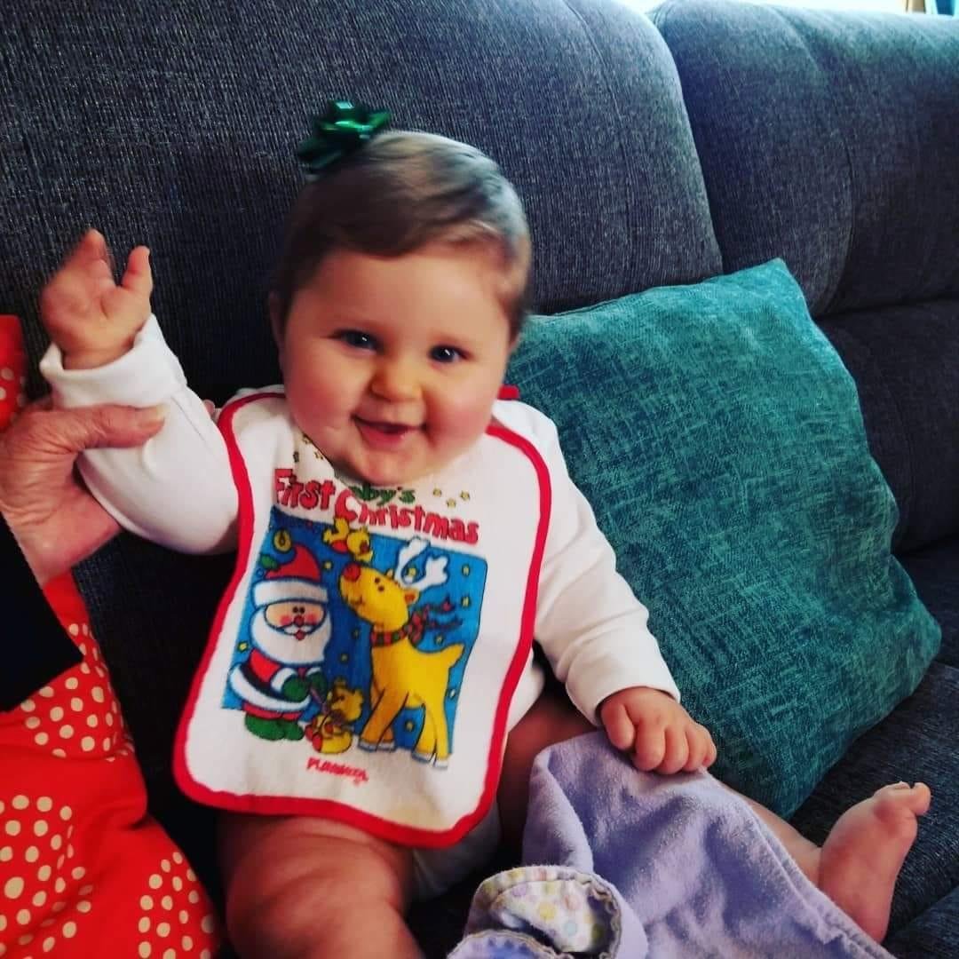 Wearing Mom's bib from 1983.