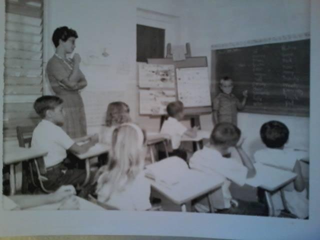 1963 classroom in hotel room near staff quarters. Mike, Alma, Jeffrey, Godfrey. front: Janet, Juan, Carol Anne.