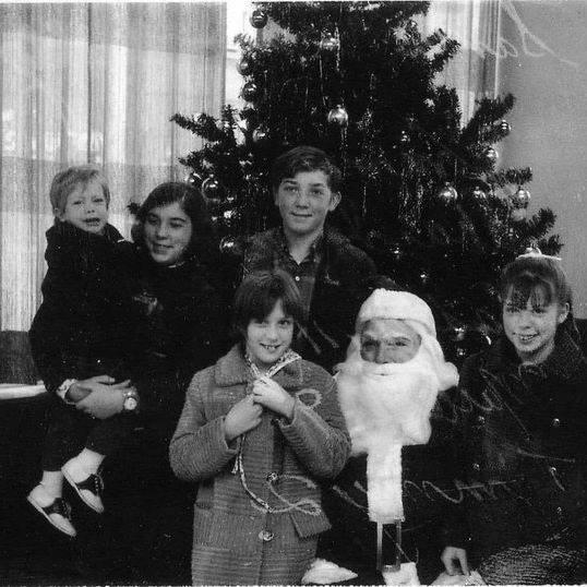 One of my dad's "side jobs" was playing Santa in a bank lobby. I love this picture of all us kids. I was 13 years old, the eldest, and the brightest (at least I thought so)😉.
Merry Christmas from the Doyle Kids