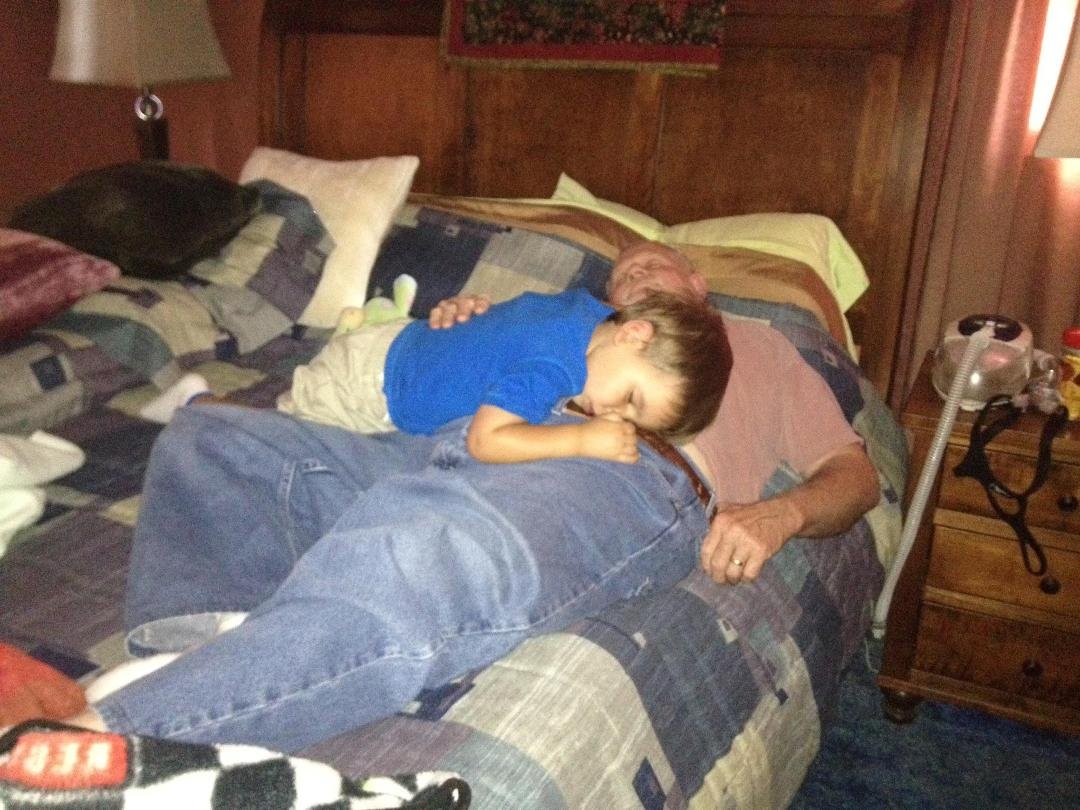 After an hour of giggling and getting out of bed 3 times ( once walking down the hall in papas shoes), this is how Kostas fell asleep with papa, for ending up being a late nap.   This was yesterday after our neighborhood wa