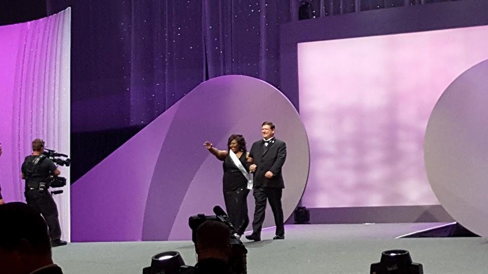 Escorted onstage to receive her prize!